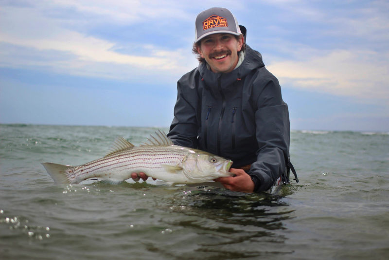 Seth Berger smiling while holding a fish.